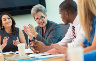 A diverse group of board members meeting around a table, representing strong governance and collaboration in a not-for-profit organisation.