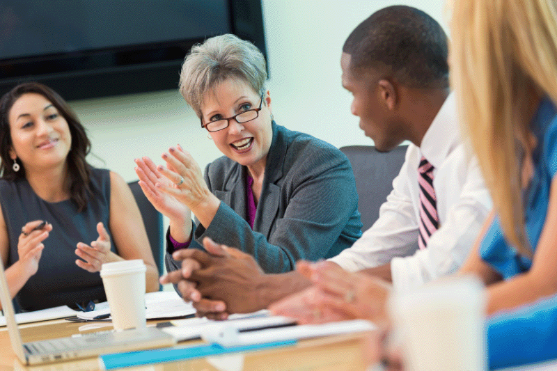 A diverse group of board members meeting around a table, representing strong governance and collaboration in a not-for-profit organisation.