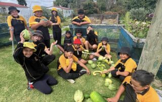 Garden to Table kids by their school vege garden